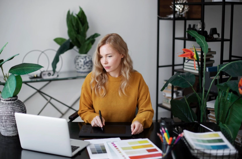 Designer reviewing colour palettes and data at a desk, human in the loop